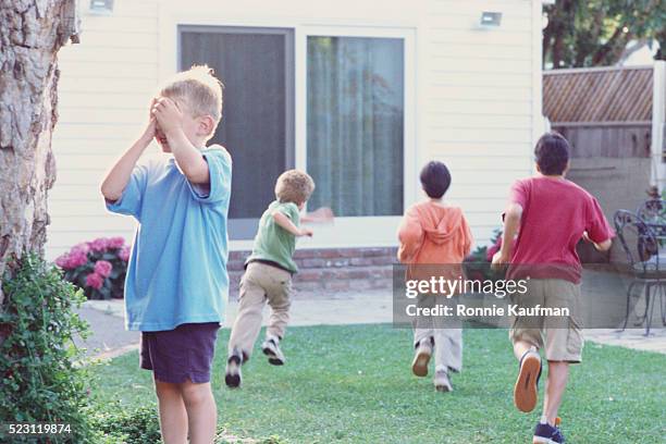 children playing hide-and-seek - hide and seek stock pictures, royalty-free photos & images