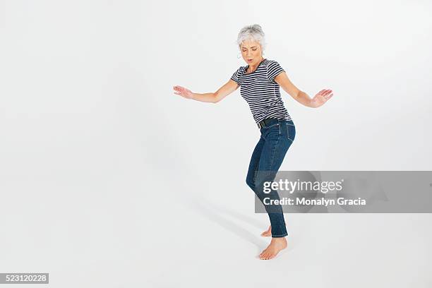 woman dancing and having fun - old person on white background stockfoto's en -beelden