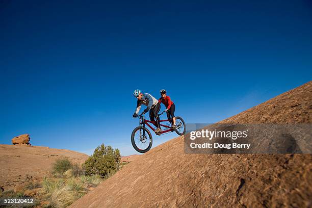 couple mountain biking on tandem - tandem bicycle stock pictures, royalty-free photos & images