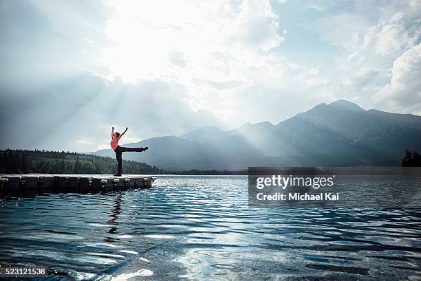 young woman doing an arabesque at pyramid lake - jetty stock pictures, royalty-free photos & images