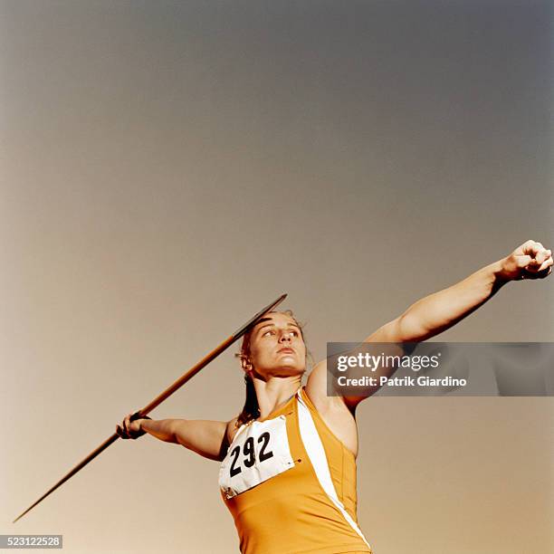 athlete throwing javelin - portrait yellow stock pictures, royalty-free photos & images