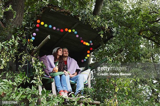 couple sitting in a secluded hut - hut stock pictures, royalty-free photos & images