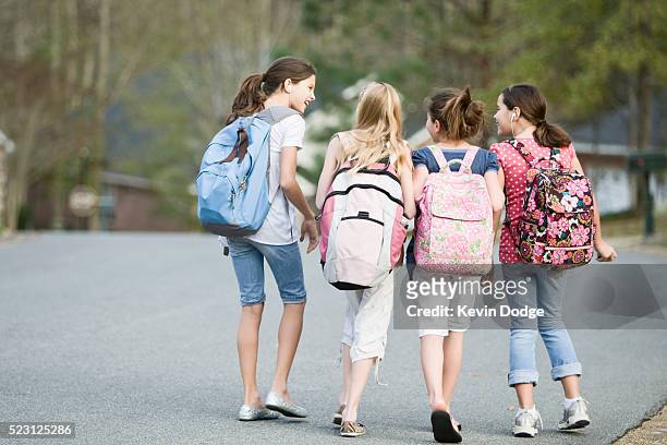 girls walking to school - kids backpack stock pictures, royalty-free photos & images