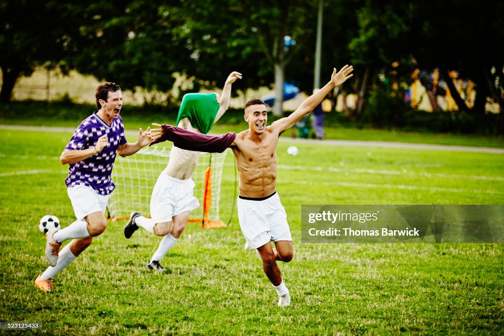 Soccer teammates celebrating after winning match