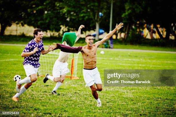 soccer teammates celebrating after winning match - seminua imagens e fotografias de stock