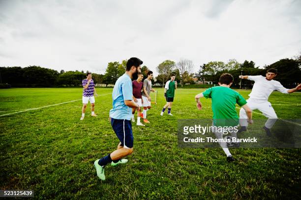 group of friends playing pick up soccer game - washington football team fotografías e imágenes de stock