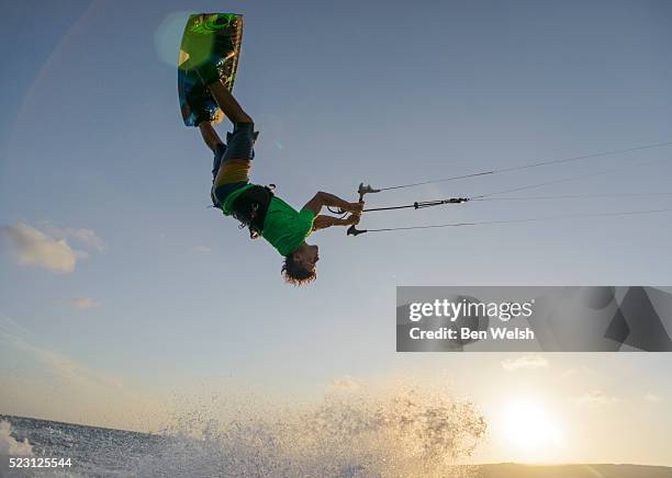 view of young man kitesurfing - kite surfing stock pictures, royalty-free photos & images
