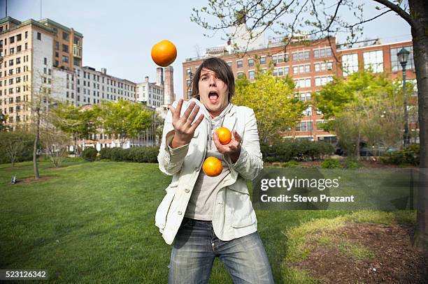 man juggling in park - juggling stockfoto's en -beelden