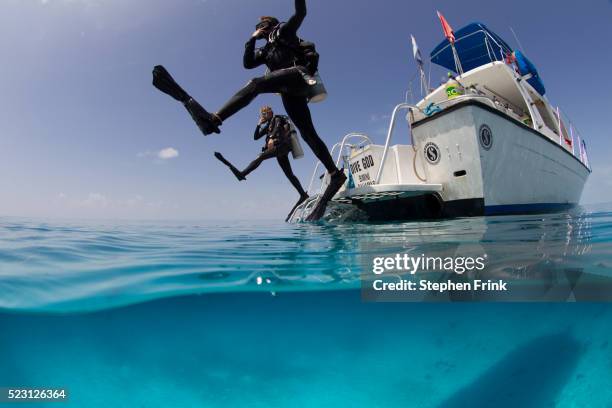 giant stride entry into calm ocean. - buceo con equipo fotografías e imágenes de stock