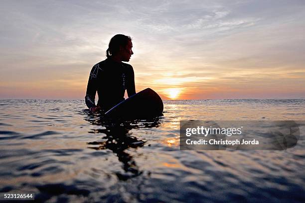 female surfer waiting for wave, praia, santiago island, cape verde - surfing island ストックフォトと画像