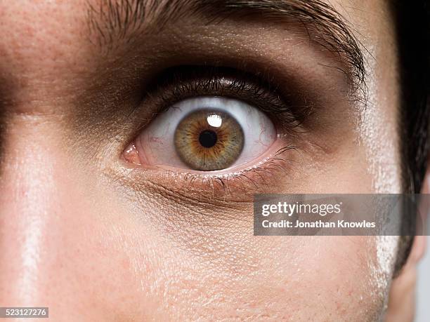 close-up of man's eye - anxious looking to camera fotografías e imágenes de stock