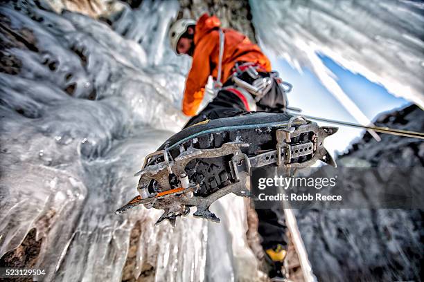 a man ice climbing on a frozen waterfall in colorado - ice climbing stockfoto's en -beelden