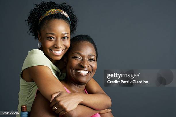 mother and daughter hugging - family formal portrait stock pictures, royalty-free photos & images