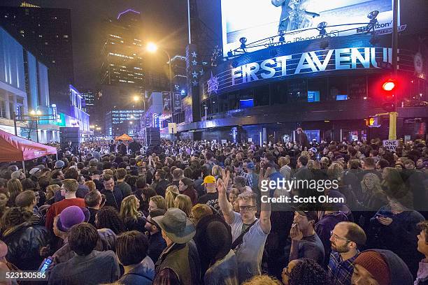 People listen to Prince music during a memorial street party outside the First Avenue nightclub on April 21, 2016 in Minneapolis, Minnesota. Prince...