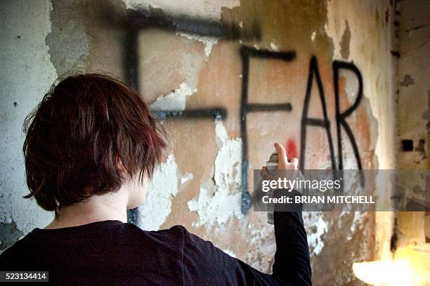 spray painting on a wall - emo stock pictures, royalty-free photos & images