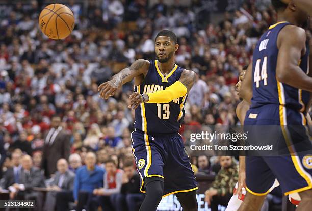 Paul George of the Indiana Pacers passes the ball against the Toronto Raptors in Game One of the Eastern Conference Quarterfinals during the 2016 NBA...