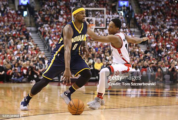 Miles of the Indiana Pacers dribbles past DeMar DeRozan of the Toronto Raptors in Game One of the Eastern Conference Quarterfinals during the 2016...