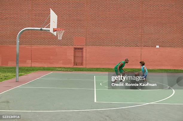 father and son playing basketball - court notice bildbanksfoton och bilder