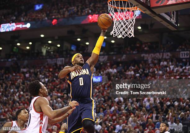 Miles of the Indiana Pacers goes up to dunk the ball against Kyle Lowry of the Toronto Raptors and DeMar DeRozan in Game One of the Eastern...