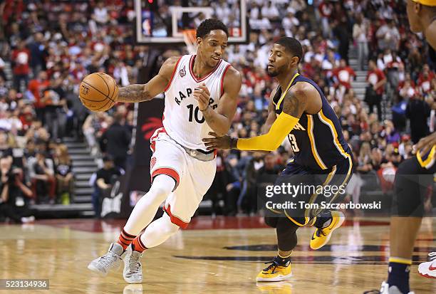 DeMar DeRozan of the Toronto Raptors makes a move to the basket against Paul George of the Indiana Pacers in Game One of the Eastern Conference...