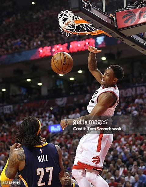 DeMar DeRozan of the Toronto Raptors dunks the ball against Jordan Hill of the Indiana Pacers in Game One of the Eastern Conference Quarterfinals...
