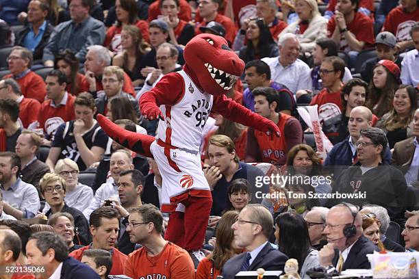 The Toronto Raptors mascot Raptor straddles the edges of a stanchion as he maintains his balance during the game against the Indiana Pacers in Game...