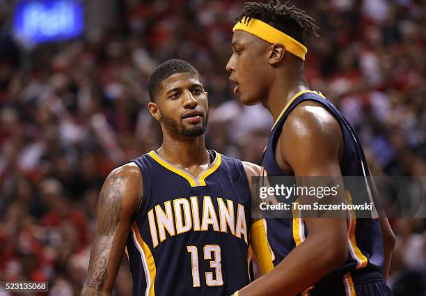 Paul George of the Indiana Pacers talks to Myles Turner during their game against the Toronto Raptors in Game One of the Eastern Conference...