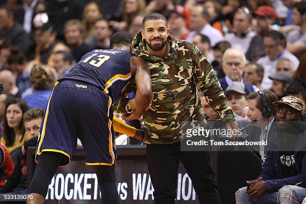 Paul George of the Indiana Pacers greets recording artist Drake against the Toronto Raptors in Game One of the Eastern Conference Quarterfinals...