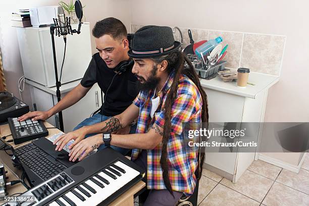 musicians working at laptop on dj table - synthesizer stock pictures, royalty-free photos & images