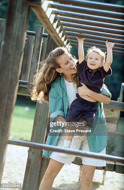 mother and child at playground - love valour compassion stock pictures, royalty-free photos & images