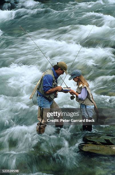 father and daughter fishing - waders imagens e fotografias de stock