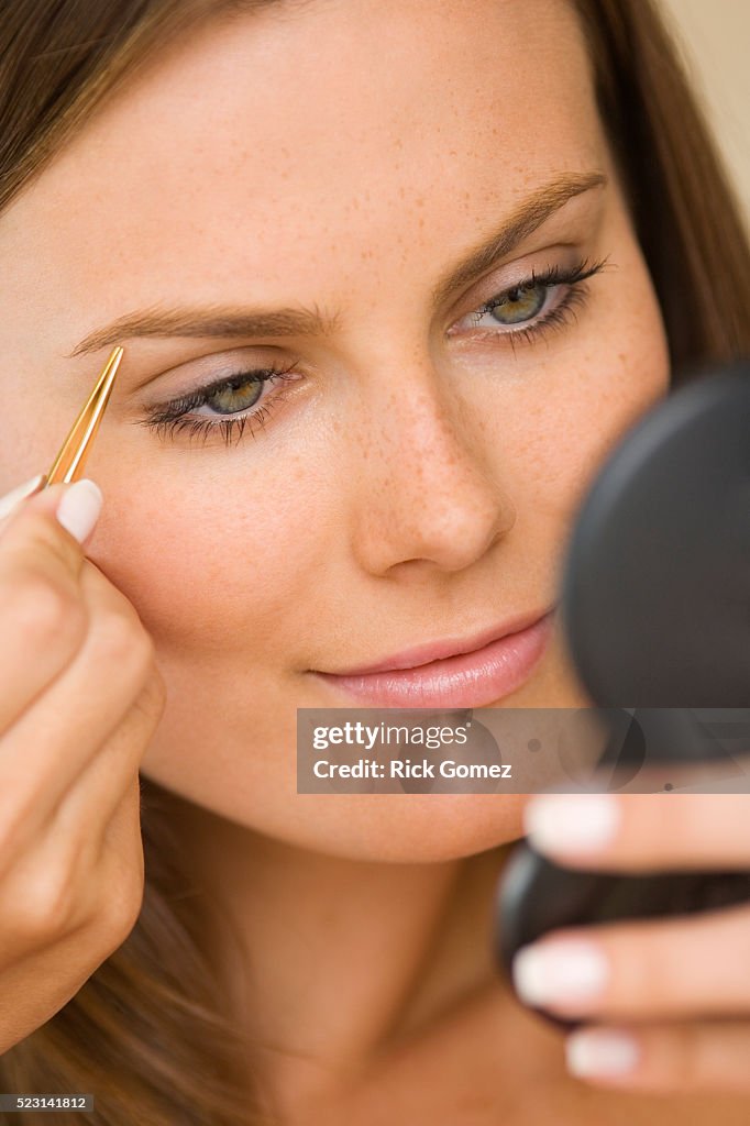 Woman Plucking Her Eyebrows