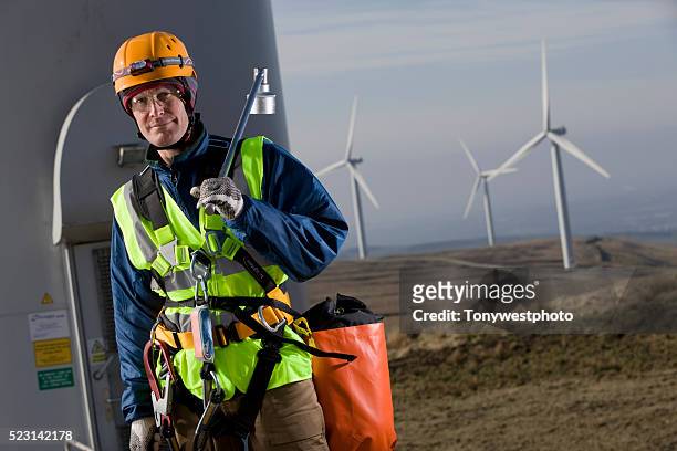 windfarm technician servicing turbines - safety equipment stock pictures, royalty-free photos & images