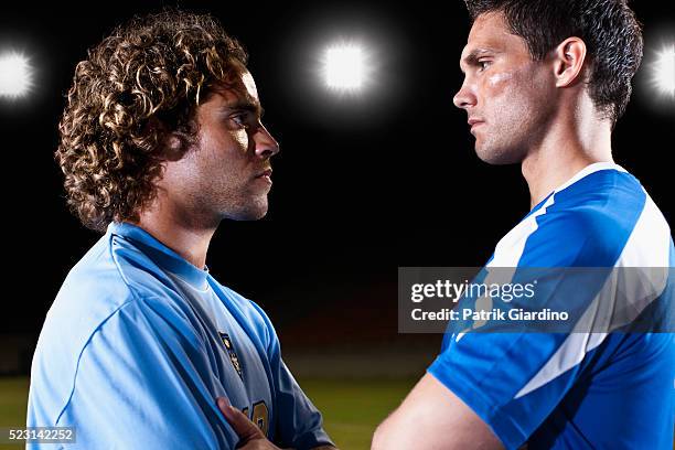 soccer players facing off - staring stock pictures, royalty-free photos & images