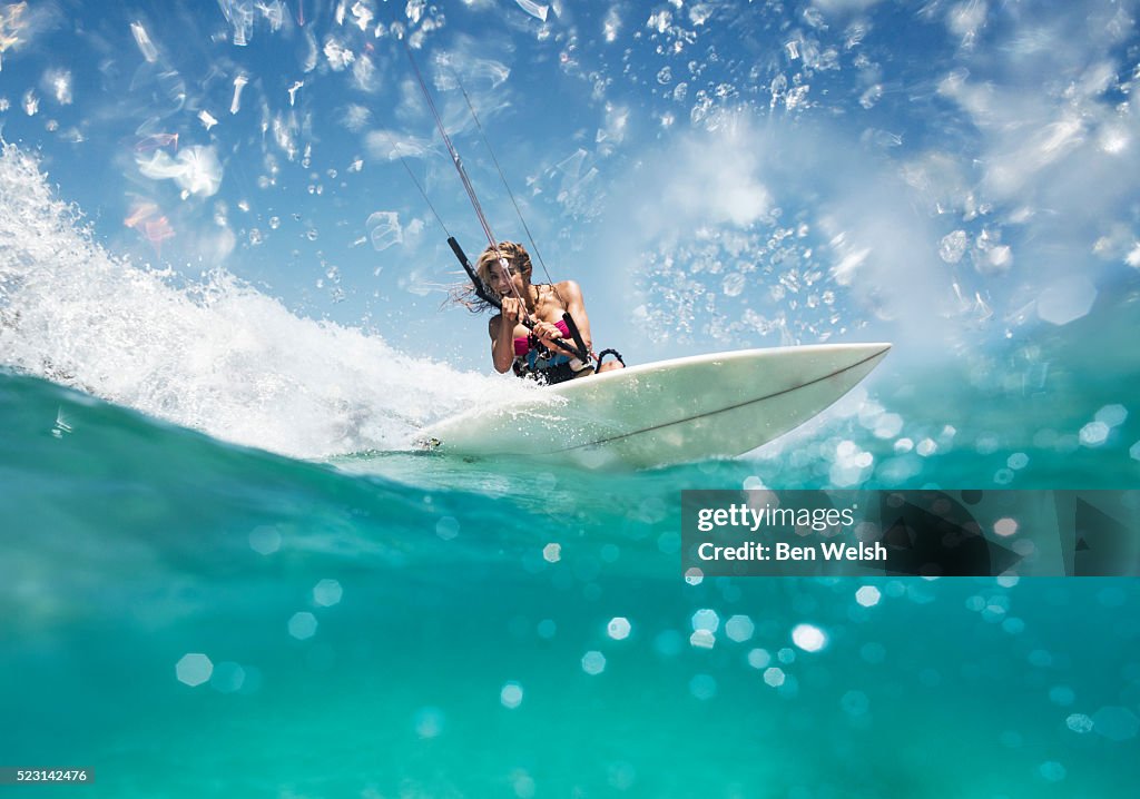 Woman enjoying ride on her kitesurfing equipment