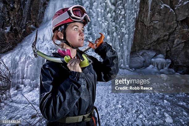 young female ice climber with ice tools - robb reece stock pictures, royalty-free photos & images