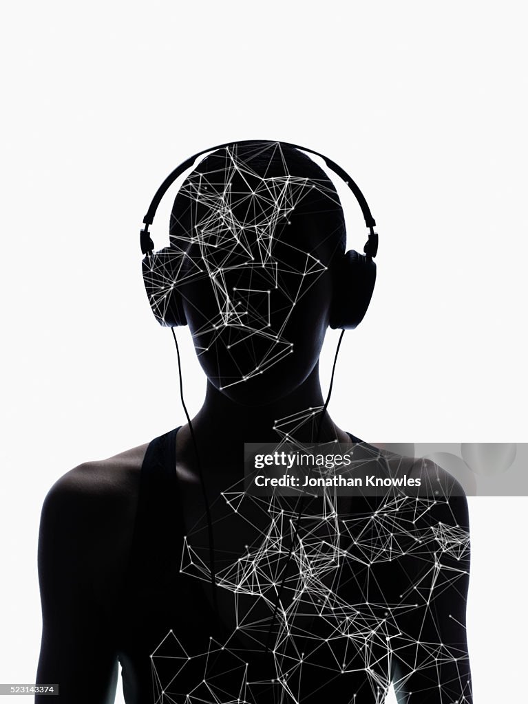 Silhouette of female wearing headphones with layer of digitally generated structure, white background