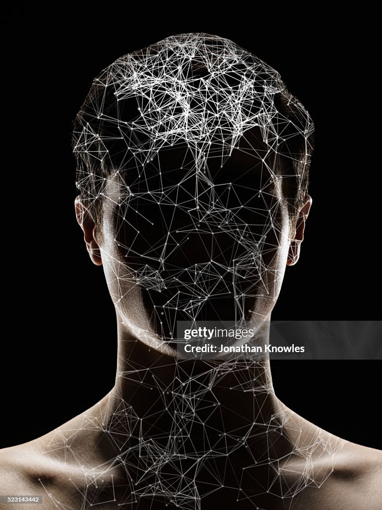 Studio shot of male head and shoulders with layer of digitally generated structure