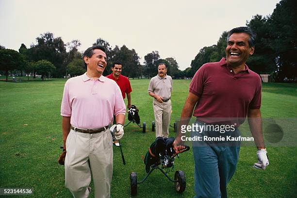 friends laughing on golf course - golfer walking stock pictures, royalty-free photos & images