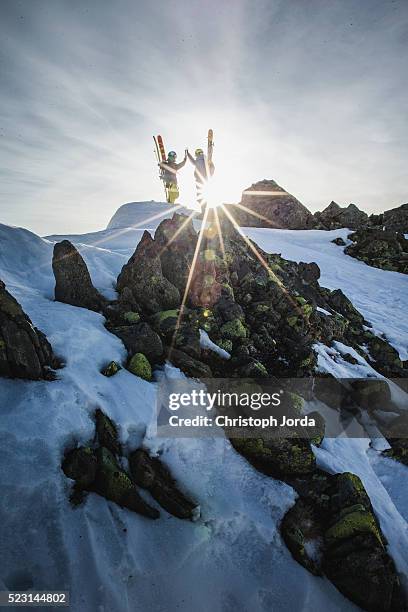 ski tourer giving each other a high five on the top of a mountain - andermatt stock pictures, royalty-free photos & images