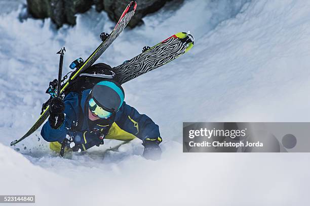 ski tourer climbing up a steep hillside - andermatt stock pictures, royalty-free photos & images