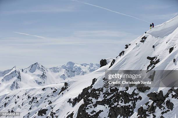 free skiers standing at the top of a hillside - andermatt stock pictures, royalty-free photos & images