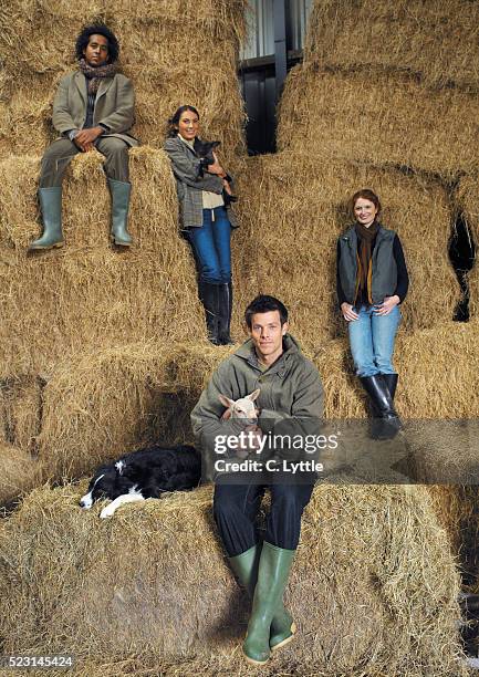 group of four young people with animals on farm - straw dogs stock pictures, royalty-free photos & images