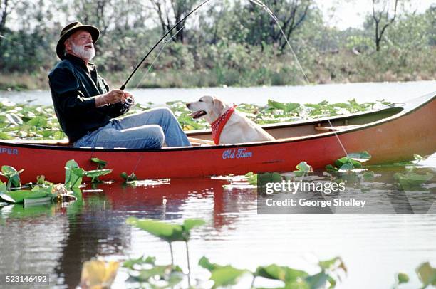 fishing buddies - seniors canoeing stock pictures, royalty-free photos & images