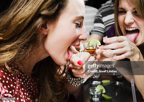 women taking tequila shots - shot glass stock pictures, royalty-free photos & images