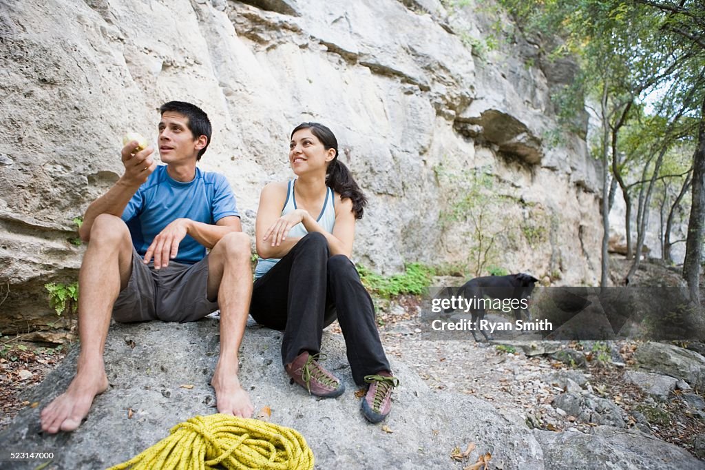 Couple Having Snack on Rock