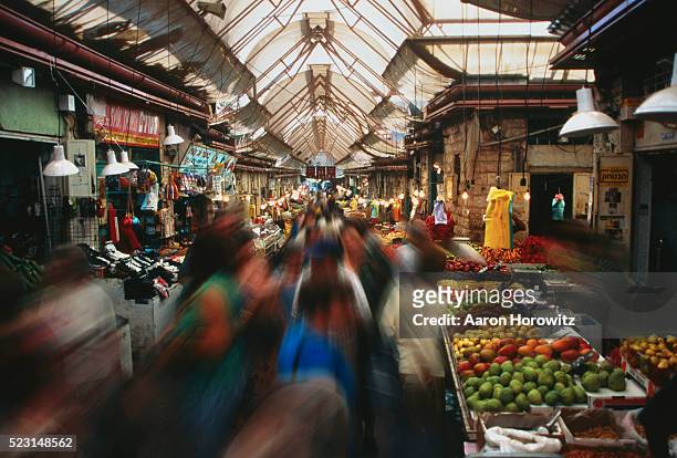 shoppers in old city market - israel market stock pictures, royalty-free photos & images