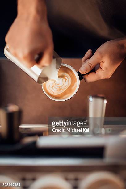barista making a latte milk coffee with milk froth - capuccino fotografías e imágenes de stock