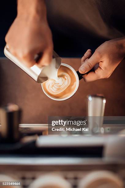 barista making a latte milk coffee with milk froth - cappuccino stock pictures, royalty-free photos & images