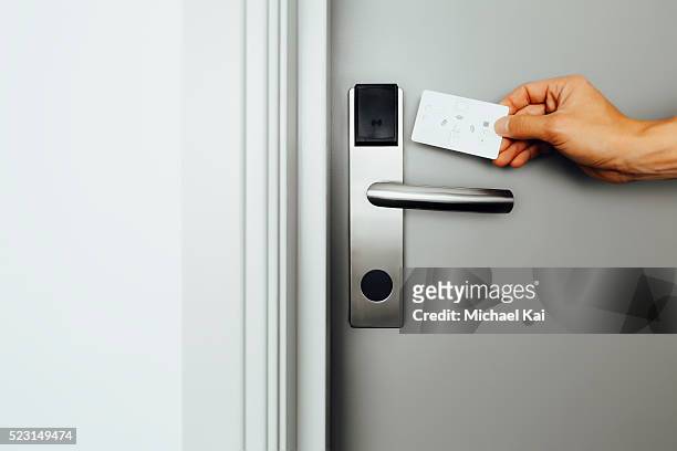 entering a hotel room with electronic lock and keycard - doorknob foto e immagini stock